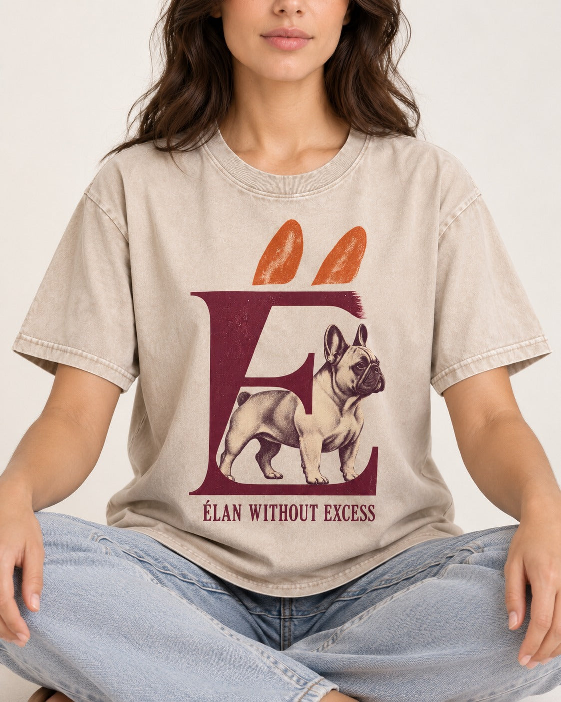 Frenchie Without Excess Washed Tee in Apricot, worn by a seated model