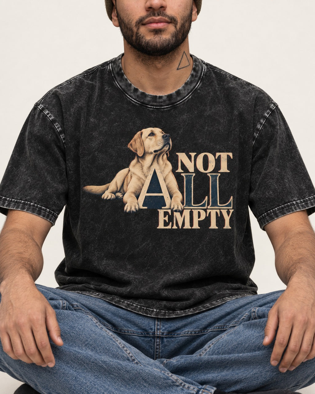 Labrador Retriever Not All Empty Lounging Typography Graphic Washed Tee in Black, worn by a seated model
