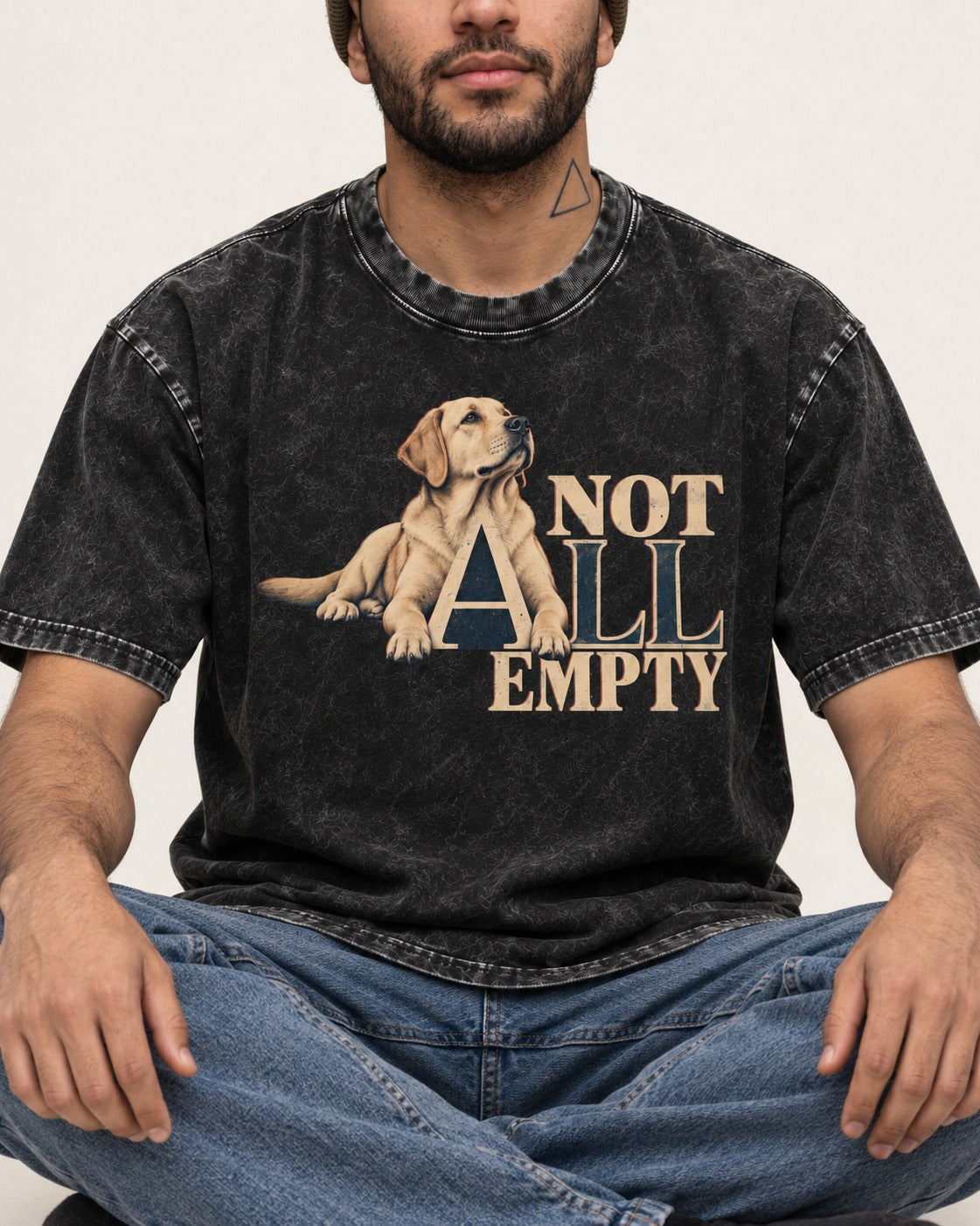 Labrador Retriever Not All Empty Lounging Typography Graphic Washed Tee in Black, worn by a seated model