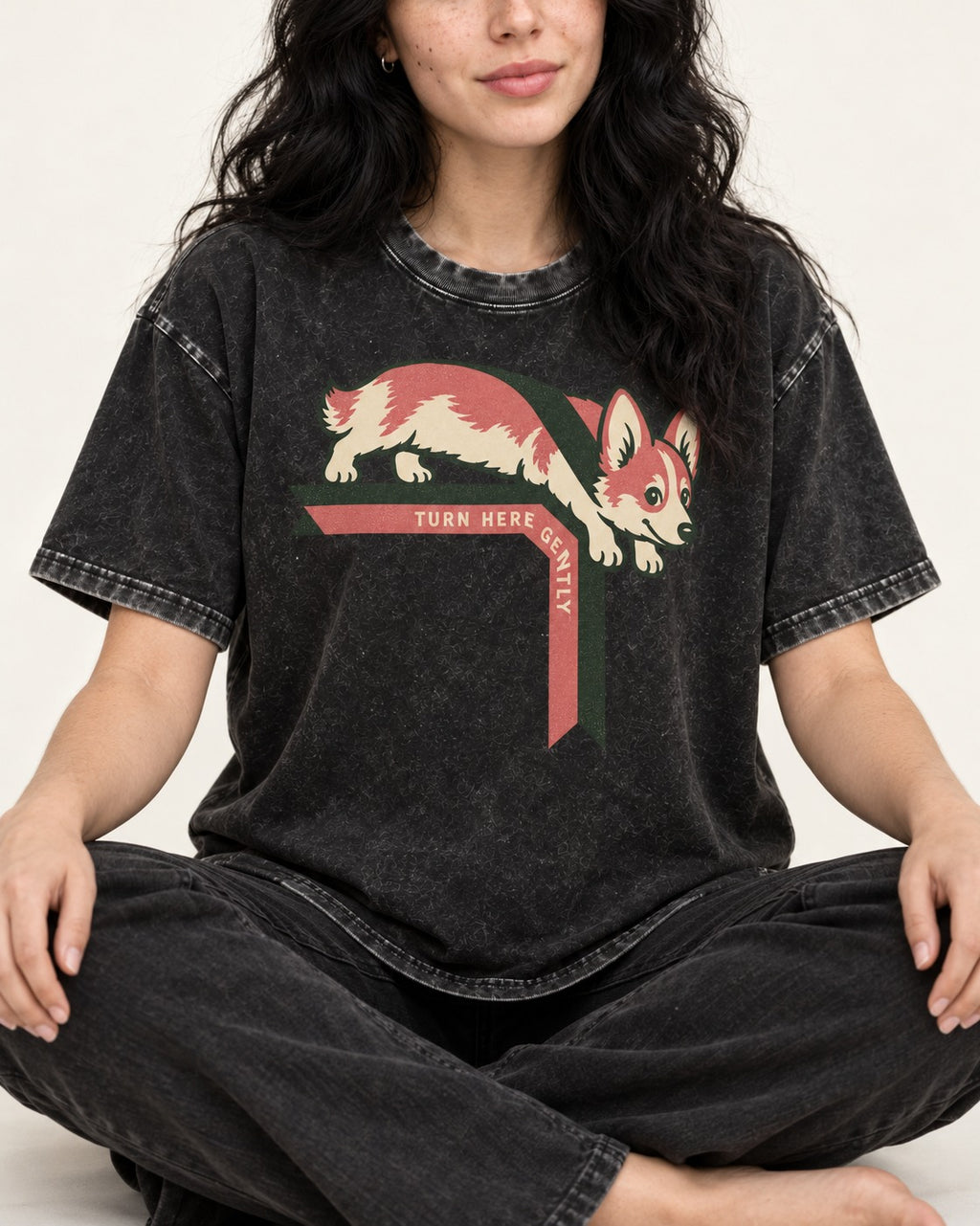 Corgi Turn Here Gently Washed Tee in Black, worn by a seated model
