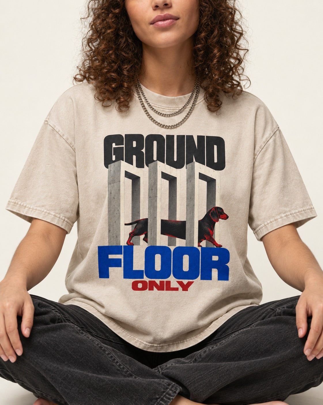 Ground Floor Only Dachshund Washed Tee in Apricot, worn by a seated model