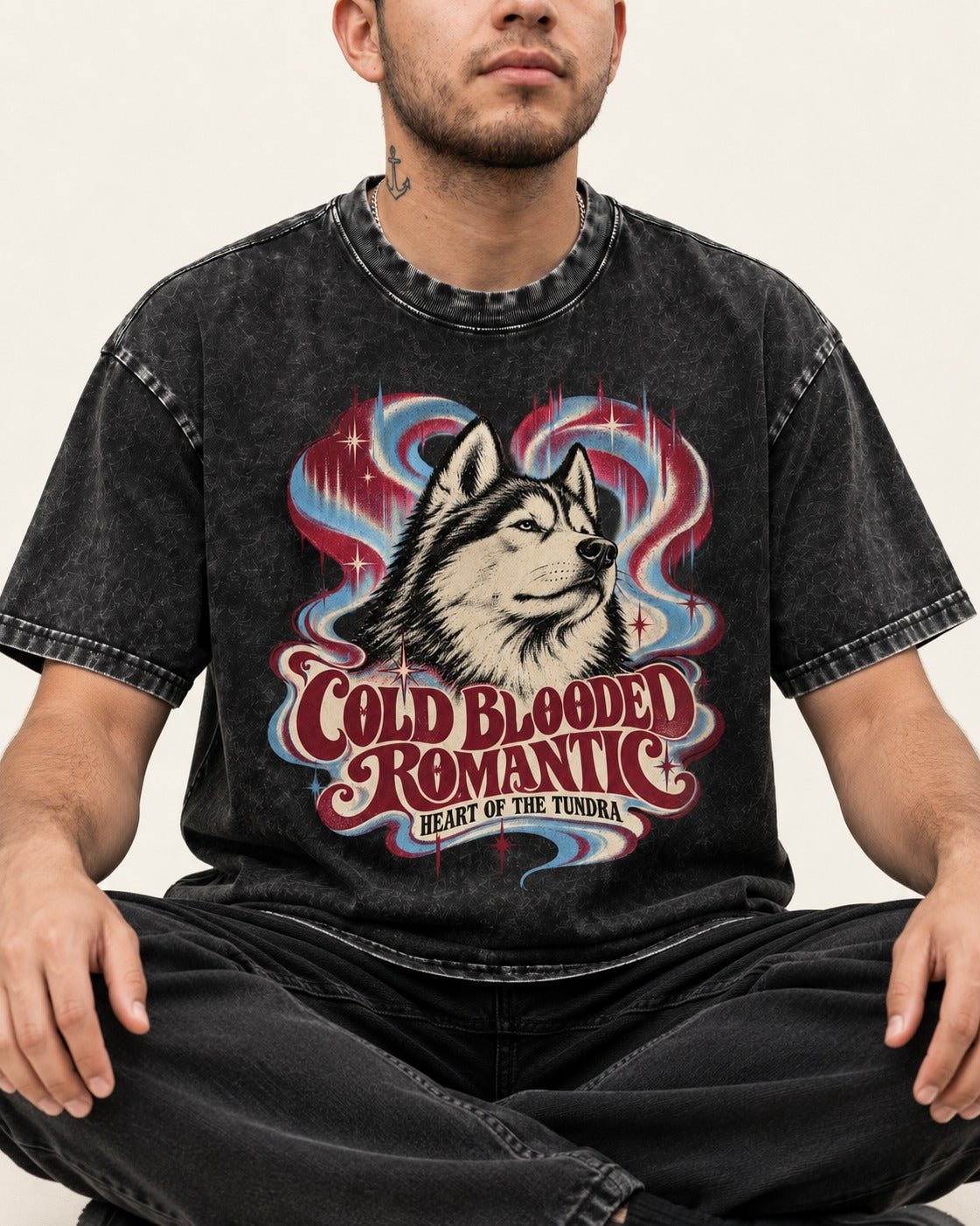 Husky Cold Blooded Romantic Heart of the Tundra Graphic Washed Tee in Black, worn by a seated model