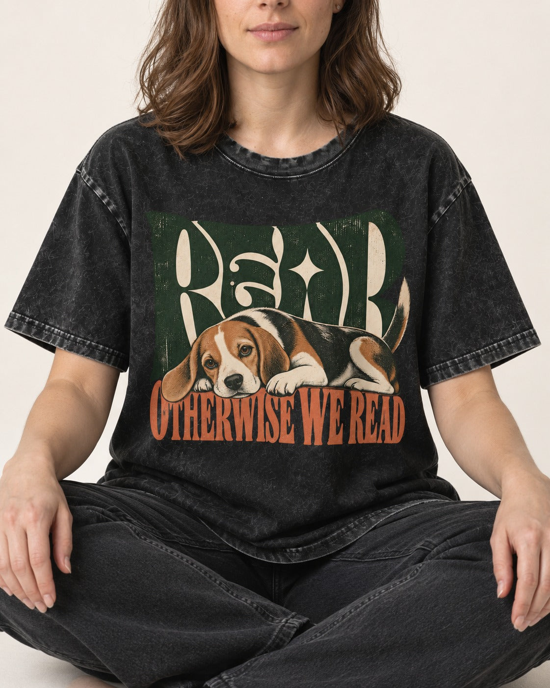 Beagle Read Otherwise We Read Retro Graphic Washed Tee in Black, worn by a seated model