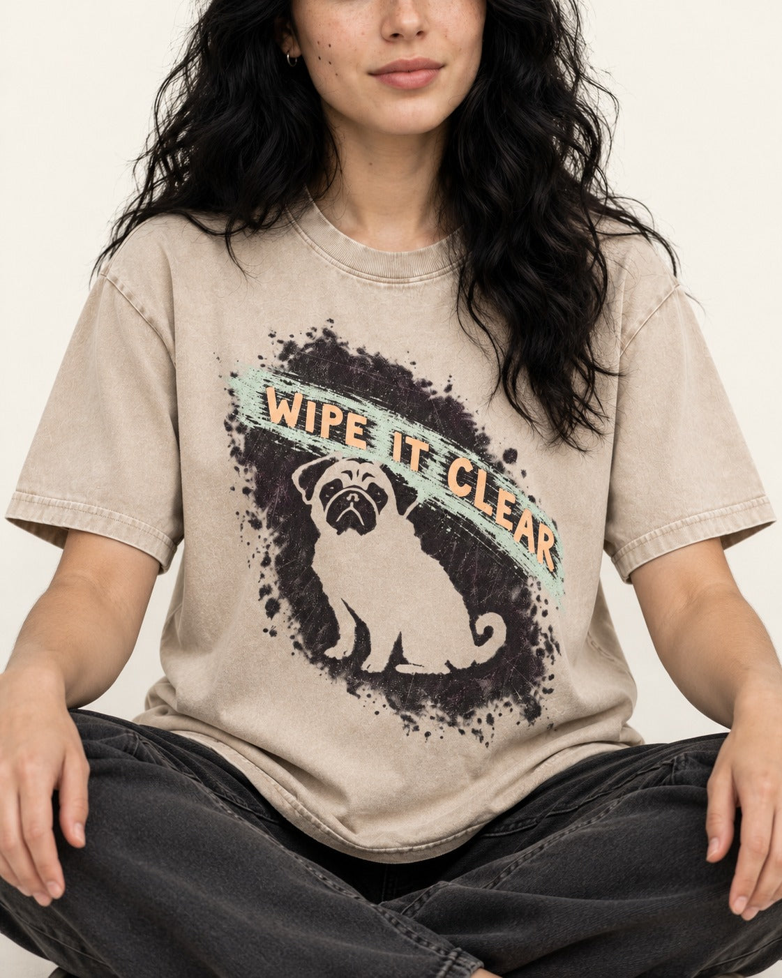 Pug Wipe It Clear Washed Tee in Apricot, worn by a seated model