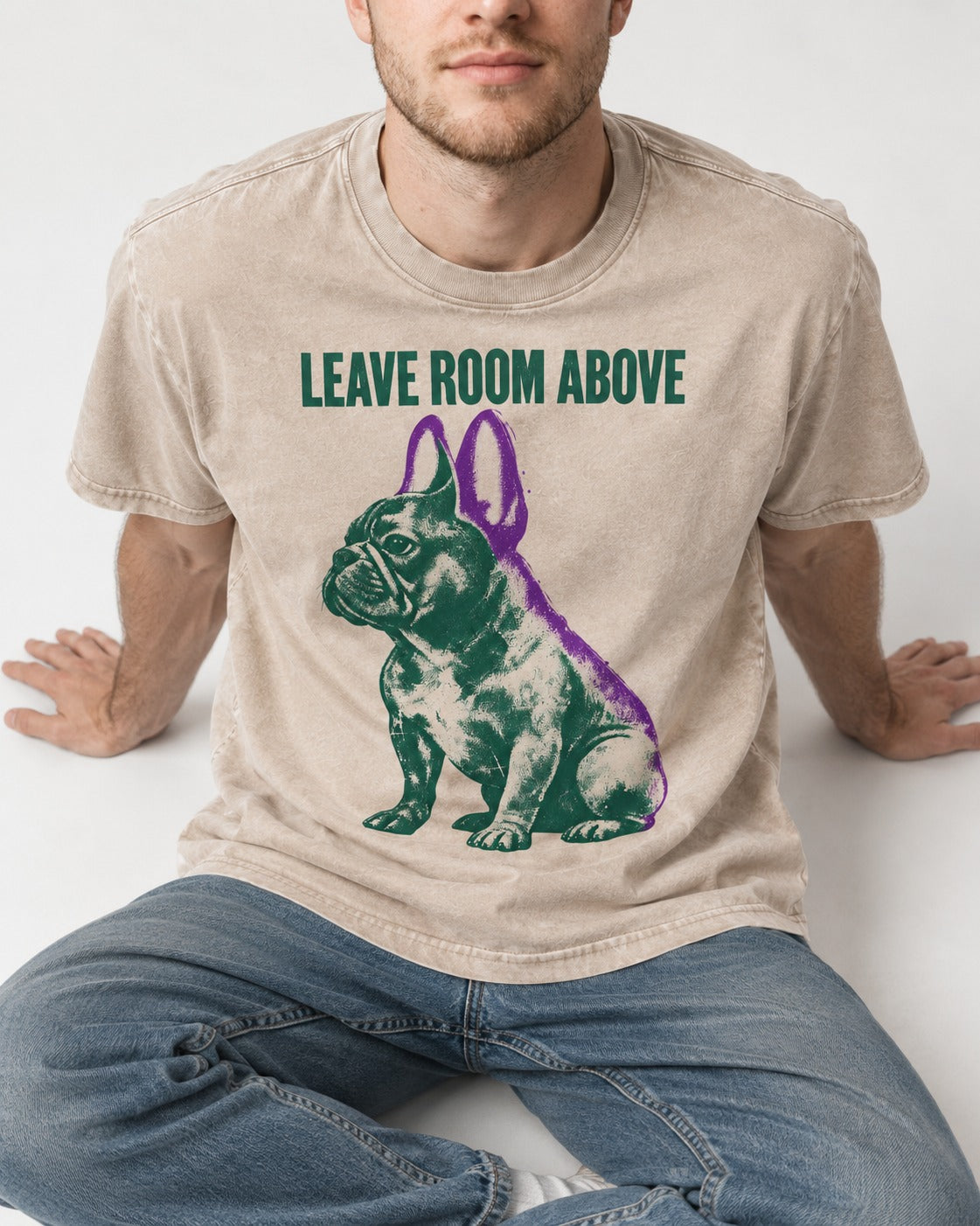 Leave Room Above Frenchie Washed Tee in Apricot, worn by a seated model