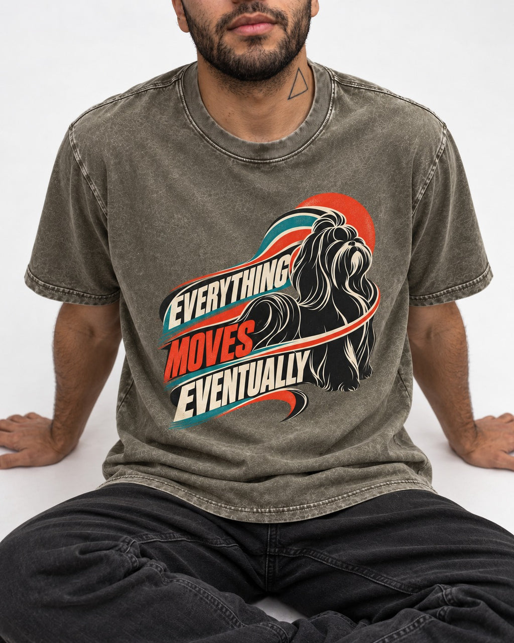Shih Tzu Everything Moves Eventually Retro Speed Graphic Washed Tee in Army Green, worn by a seated model