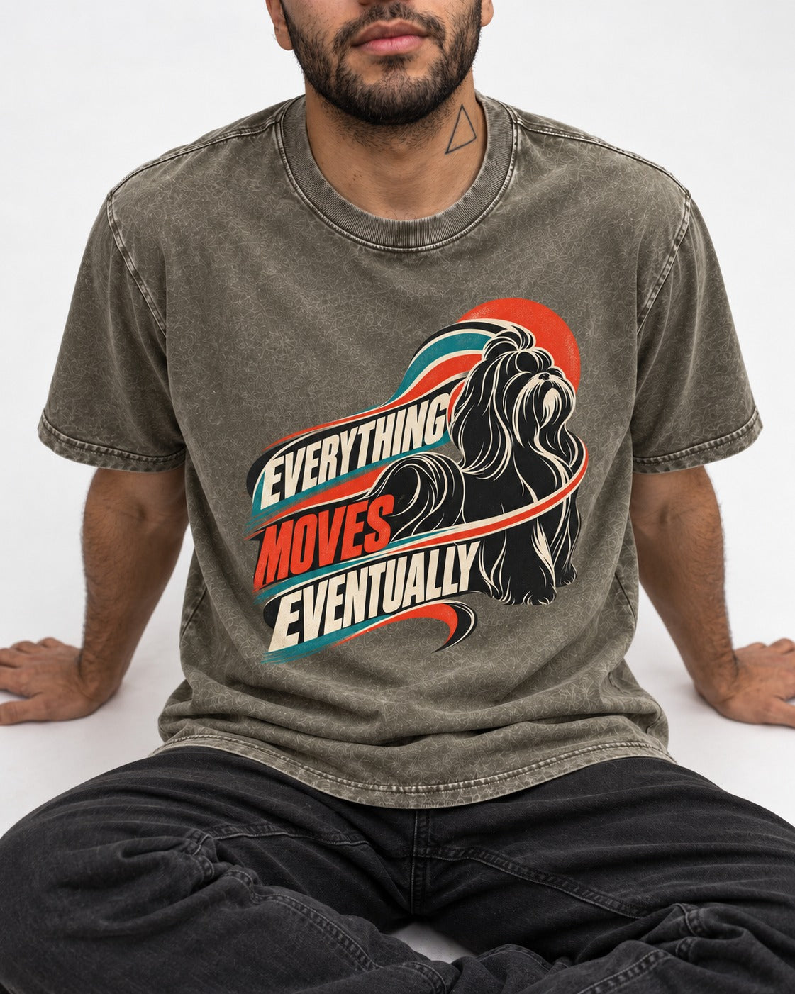 Shih Tzu Everything Moves Eventually Retro Speed Graphic Washed Tee in Army Green, worn by a seated model