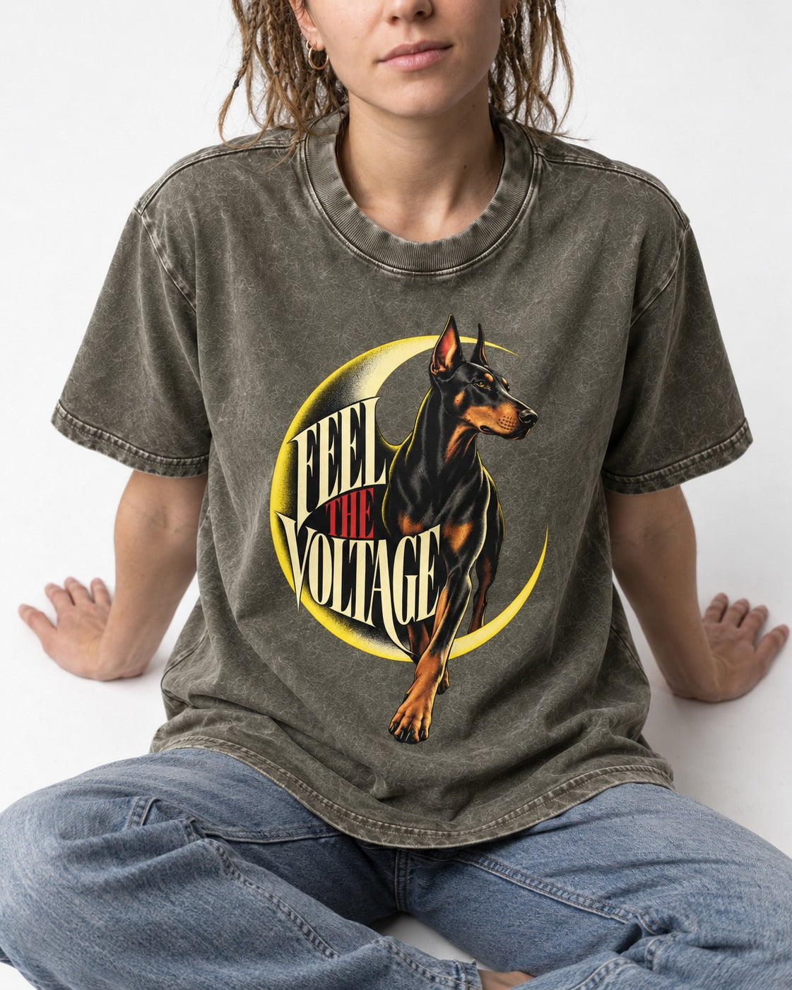 Doberman Feel the Voltage Crescent Portrait Graphic Washed Tee in Army Green, worn by a seated model