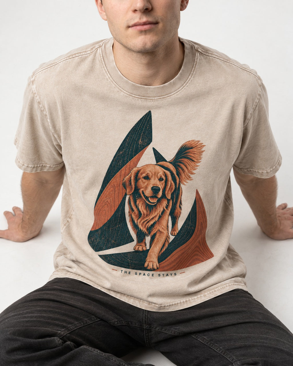 The Golden Retriever Space Stays Washed Tee in Apricot, worn by a seated model