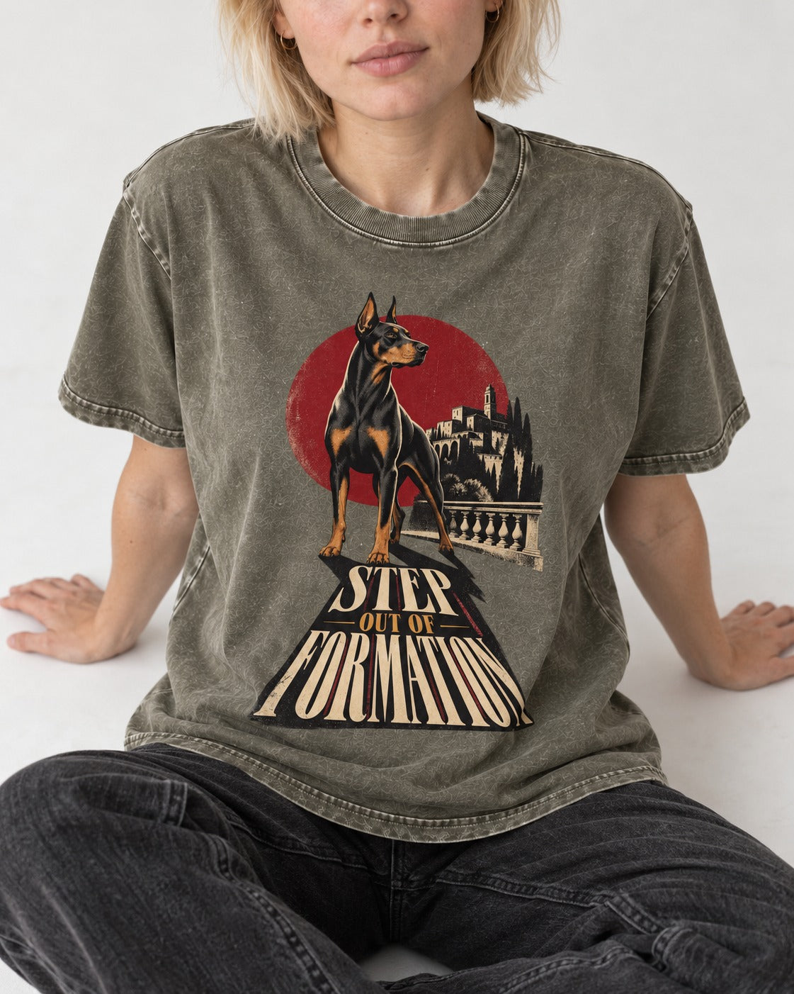 Doberman Step Out of Formation Road Vista Graphic Washed Tee in Army Green, worn by a seated model