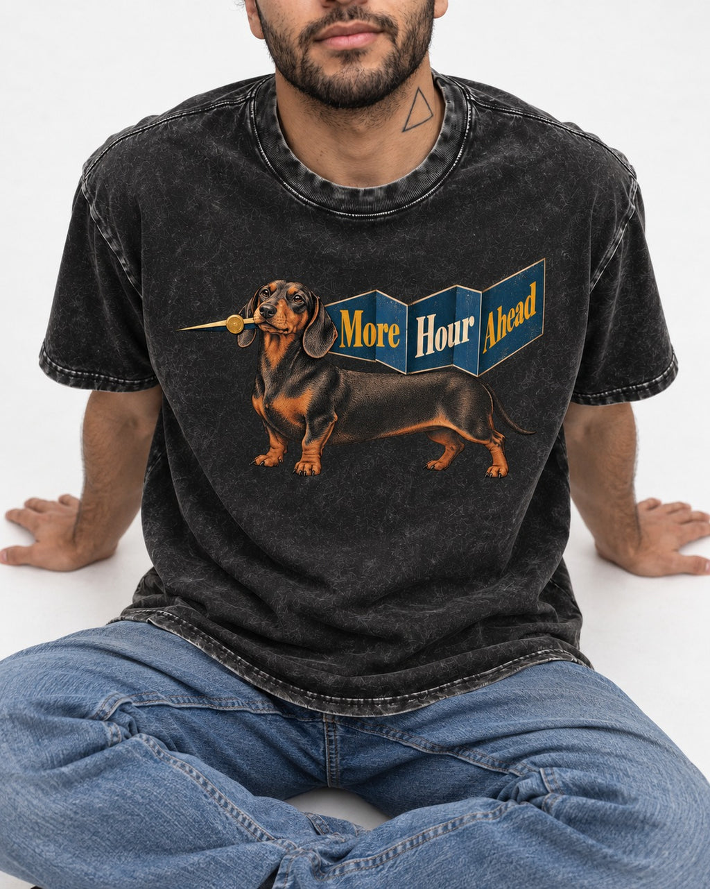 Dachshund More Hour Ahead Foldout Banner Graphic Washed Tee in Black, worn by a seated model