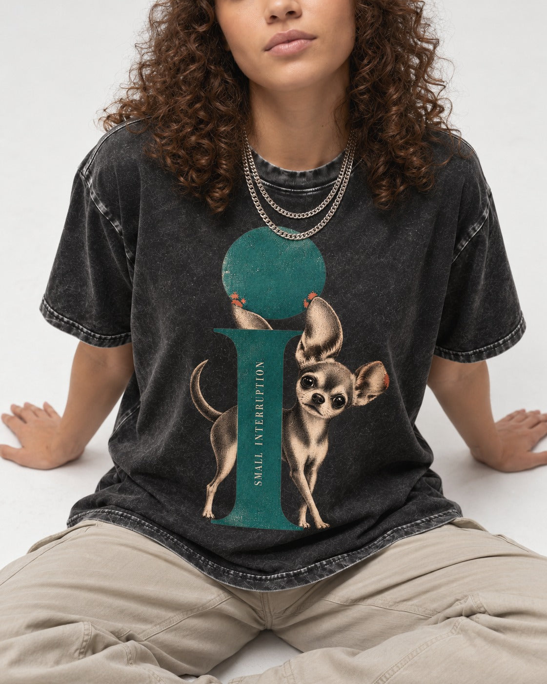 Chihuahua Small Interruption Geometric Portrait Washed Tee in Black, worn by a seated model