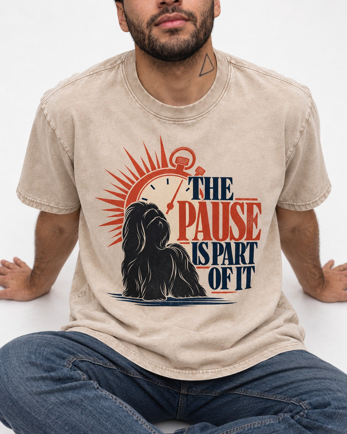 The Shih Tzu Pause Washed Tee in Apricot, worn by a seated model