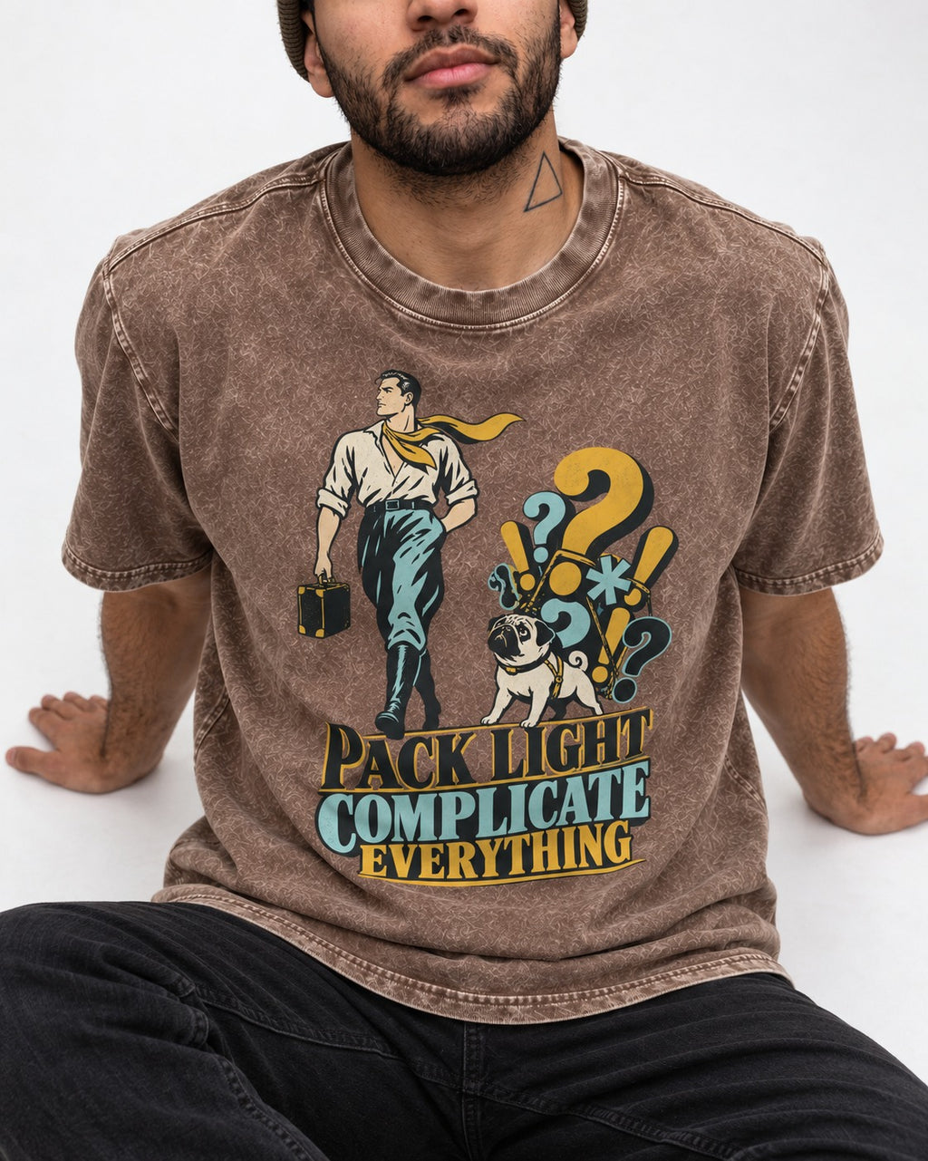 Pug Pack Light Complicate Everything Washed Tee in Coffee, worn by a seated model