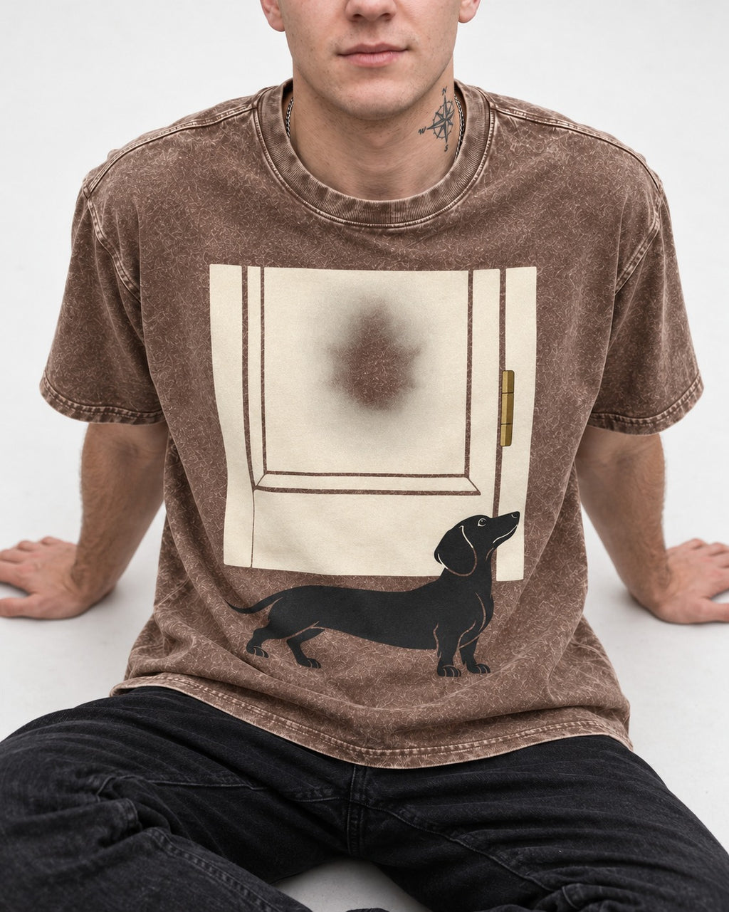 Dachshund Frosted Door Sentinel Graphic Washed Tee in Coffee, worn by a seated model