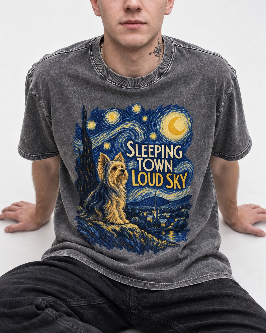 Yorkshire Terrier Sleeping Town Loud Sky Starry Night Graphic Washed Tee in Gray, worn by a seated model