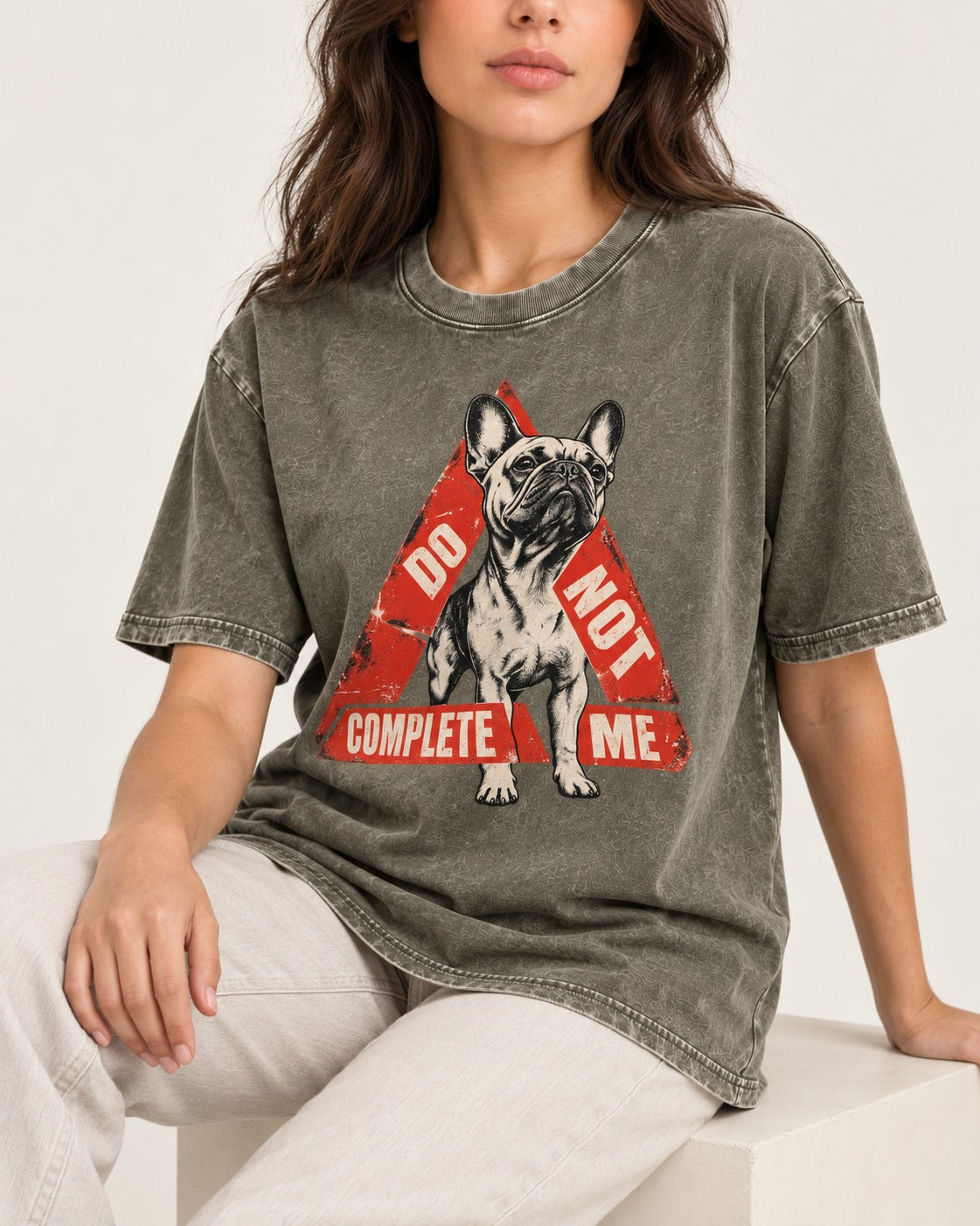 Frenchie Do Not Complete Me Warning Triangle Graphic Washed Tee in Army Green, worn by a seated model
