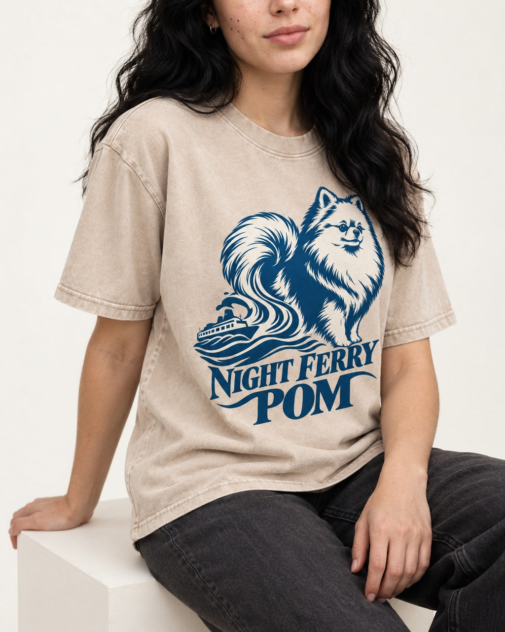 Night Ferry Pomeranian Washed Tee in Apricot, worn by a seated model