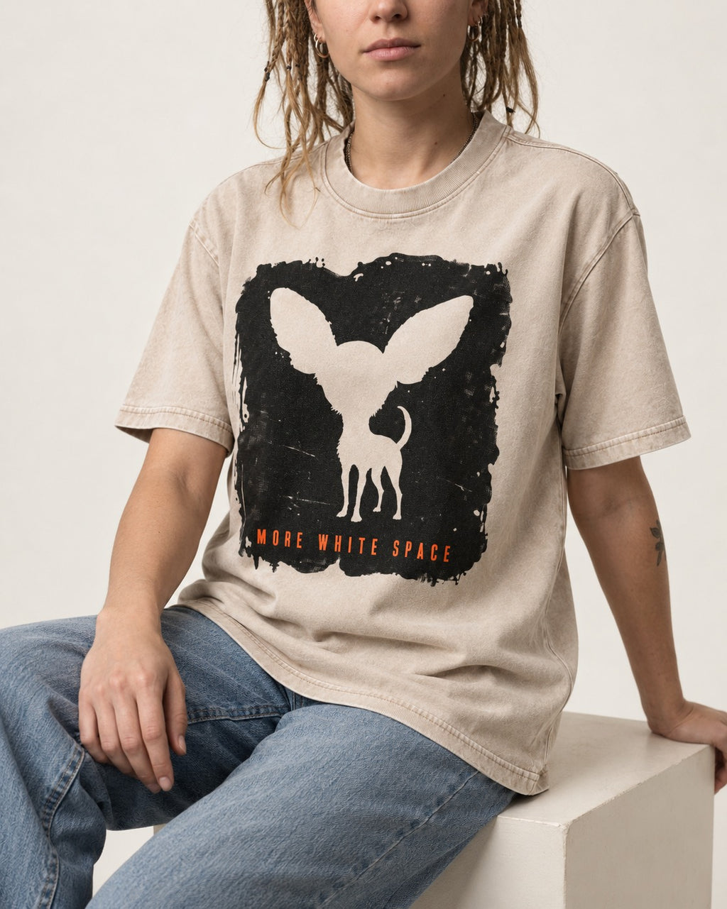 More White Space Chihuahua Washed Tee in Apricot, worn by a seated model