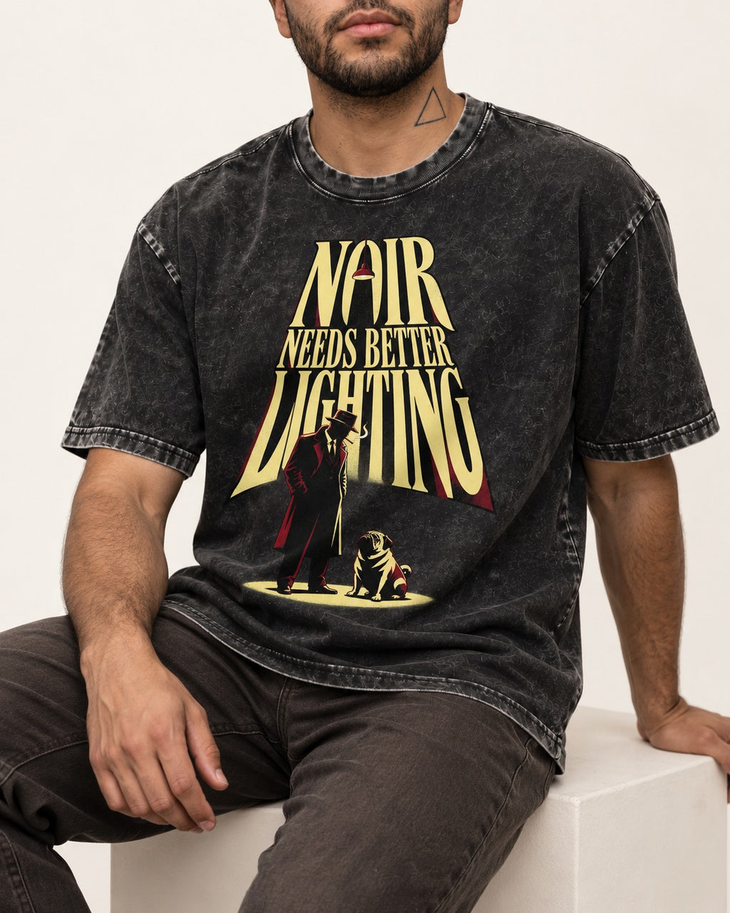 Pug Noir Needs Better Lighting Detective Graphic Washed Tee in Black, worn by a seated model