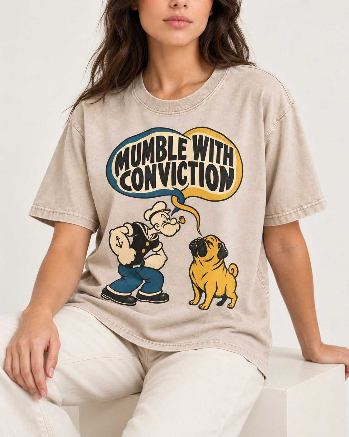 Pug Mumble with Conviction Washed Tee in Apricot, worn by a seated model