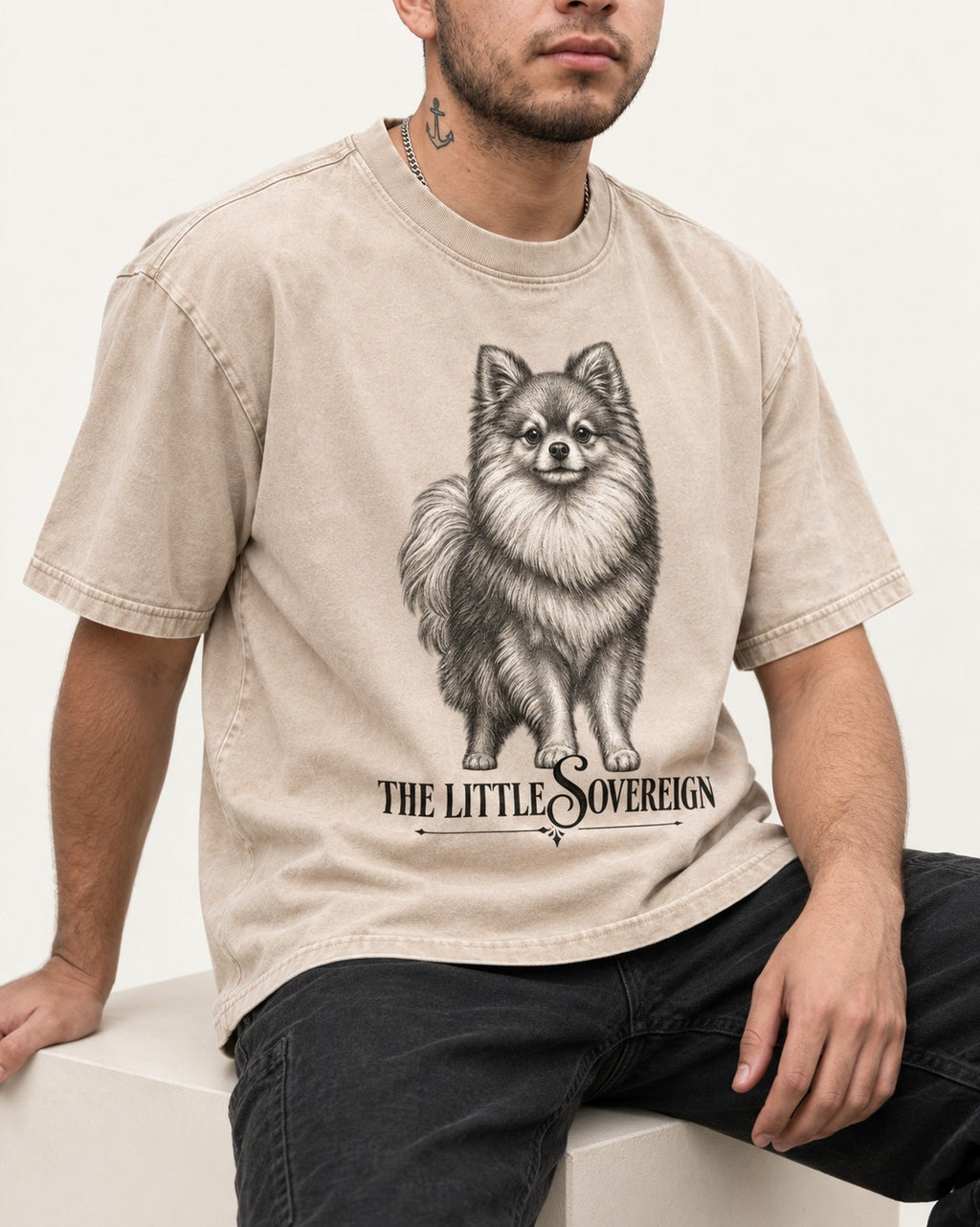 The Little Sovereign Pomeranian Washed Tee in Apricot, worn by a seated model