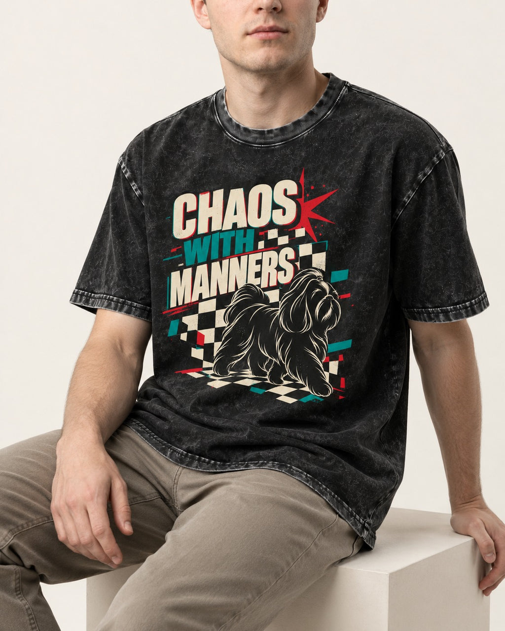 Shih Tzu Chaos with Manners Checkerboard Graphic Washed Tee in Black, worn by a seated model