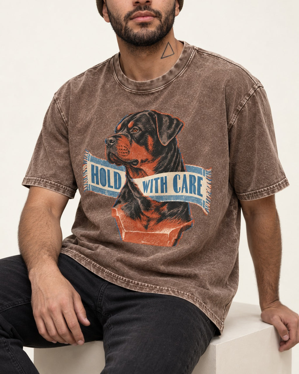 Rottweiler Hold with Care Washed Tee in Coffee, worn by a seated model