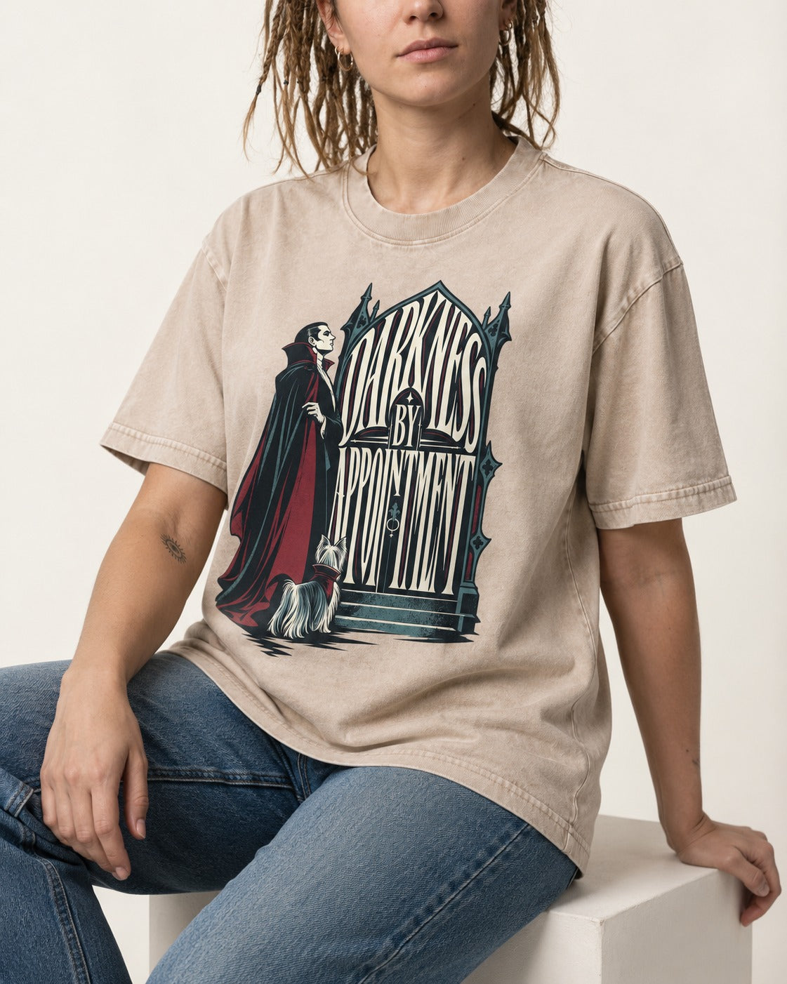 Darkness by Appointment with Yorkshire Terrier Washed Tee in Apricot, worn by a seated model