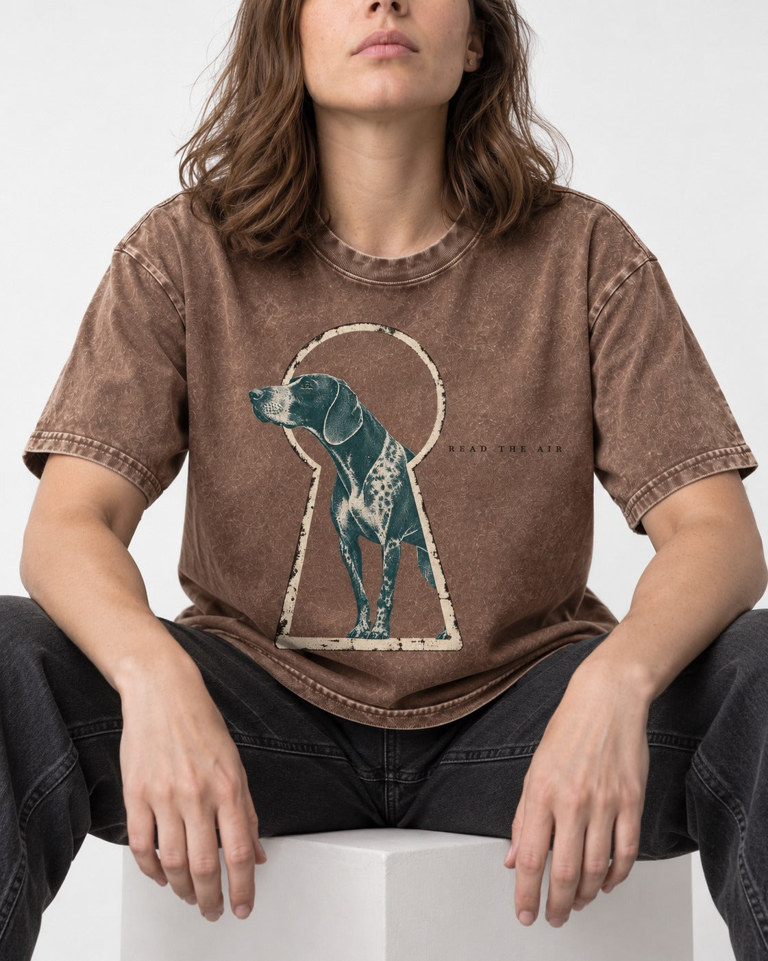 Read the Air German Shorthaired Pointer Washed Tee in Coffee, worn by a seated model