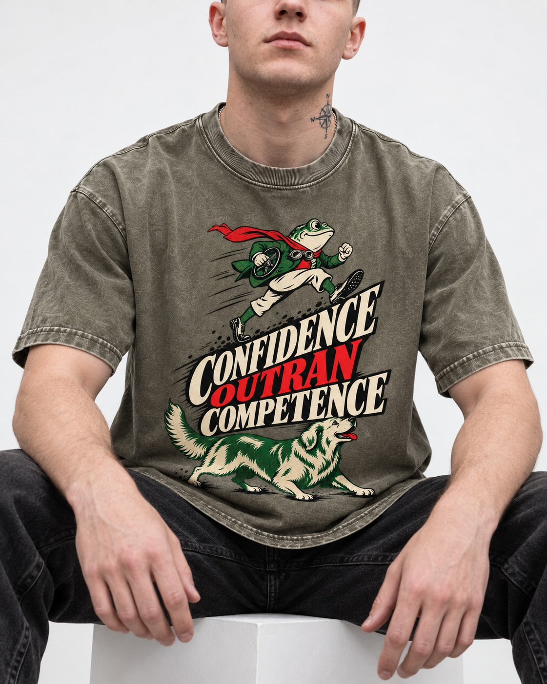 Golden Retriever Confidence Outran Competence Racing Graphic Washed Tee in Army Green, worn by a seated model