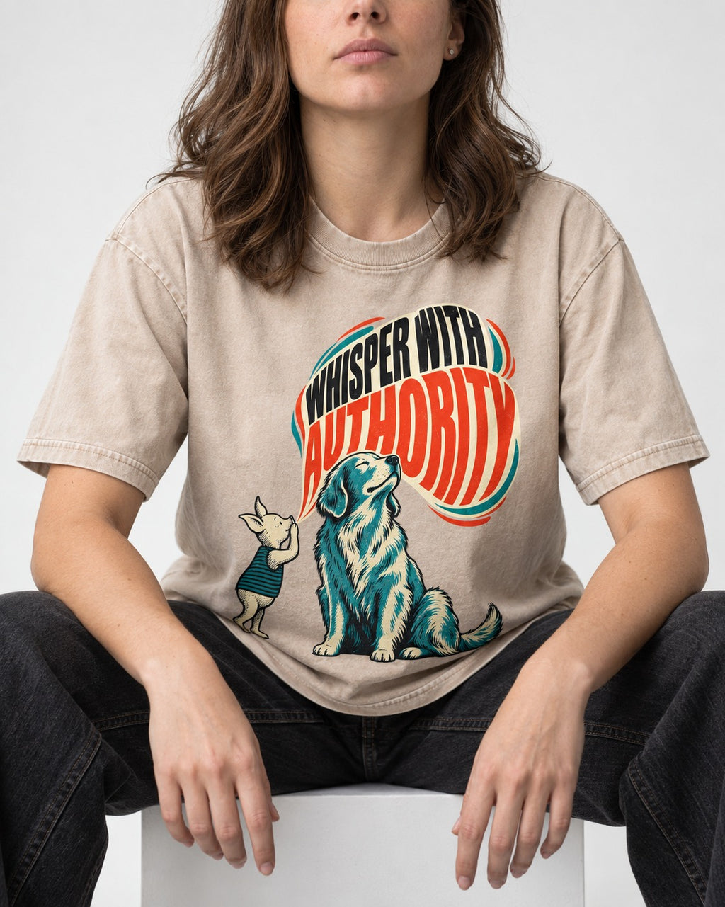 Golden Retriever Whisper with Authority Washed Tee in Apricot, worn by a seated model
