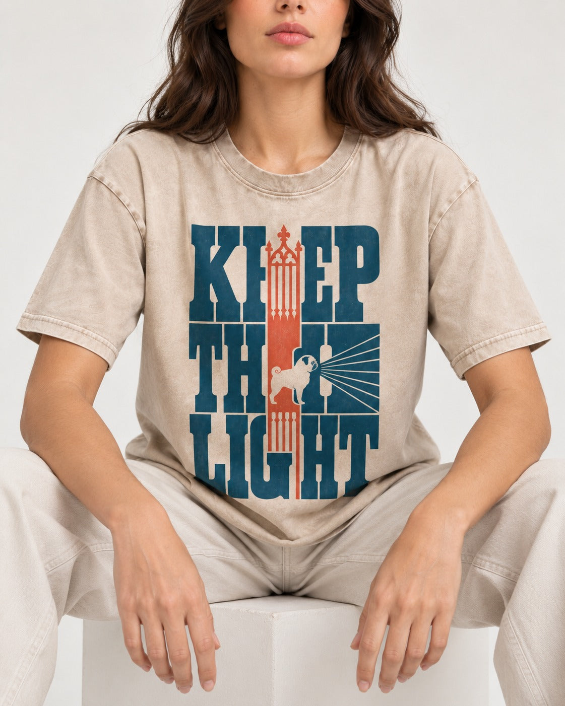 Keep the Pug Fight Washed Tee in Apricot, worn by a seated model