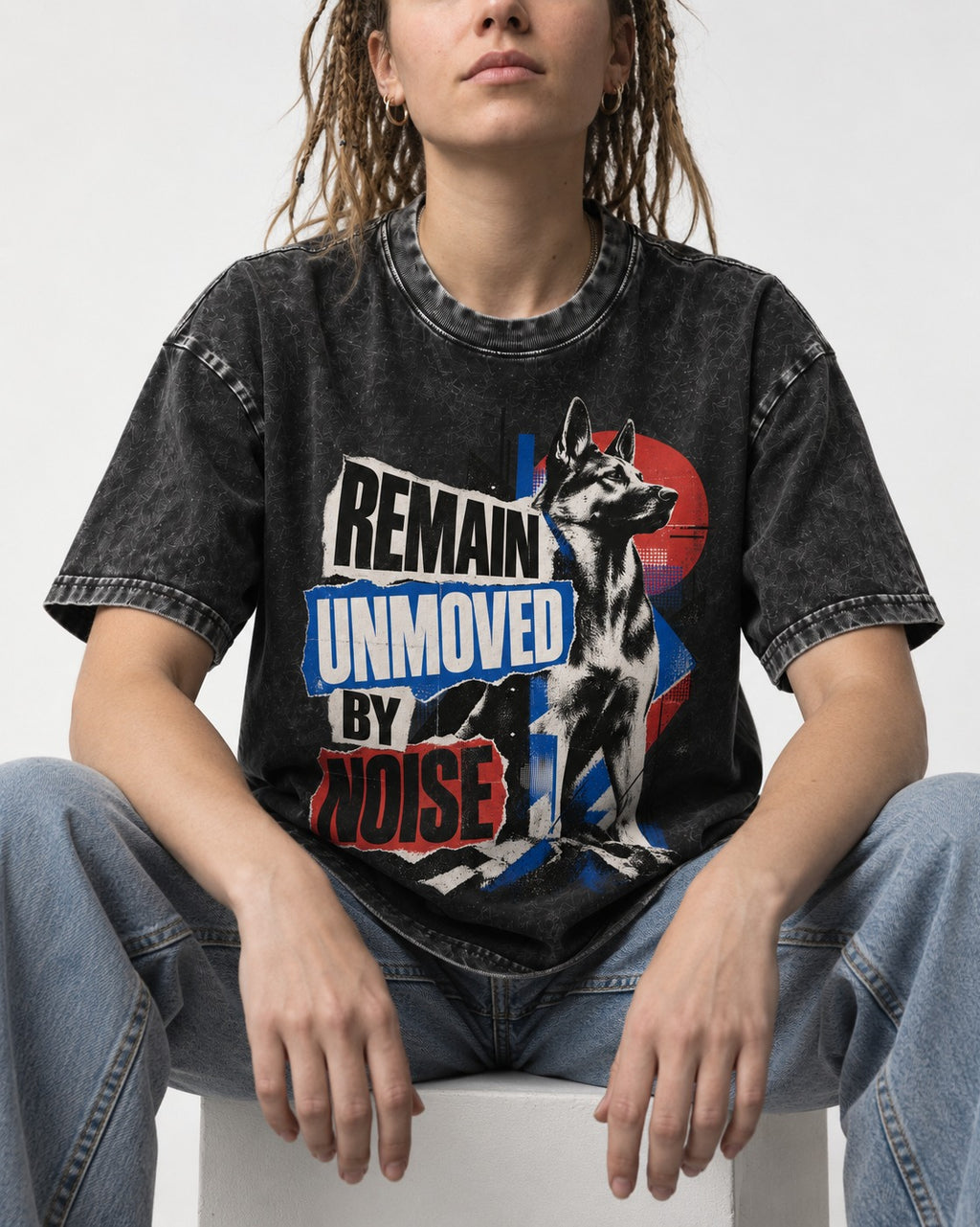 Remain Unmoved By Noise Brutalist Collage German Shepherd Dog Graphic Washed Tee in Black, worn by a seated model