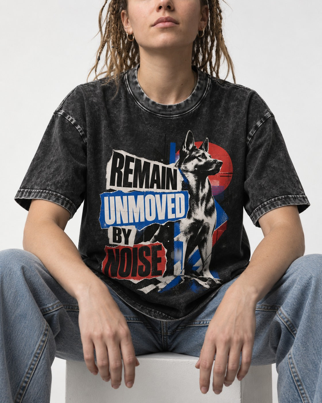 Remain Unmoved By Noise Brutalist Collage German Shepherd Dog Graphic Washed Tee in Black, worn by a seated model