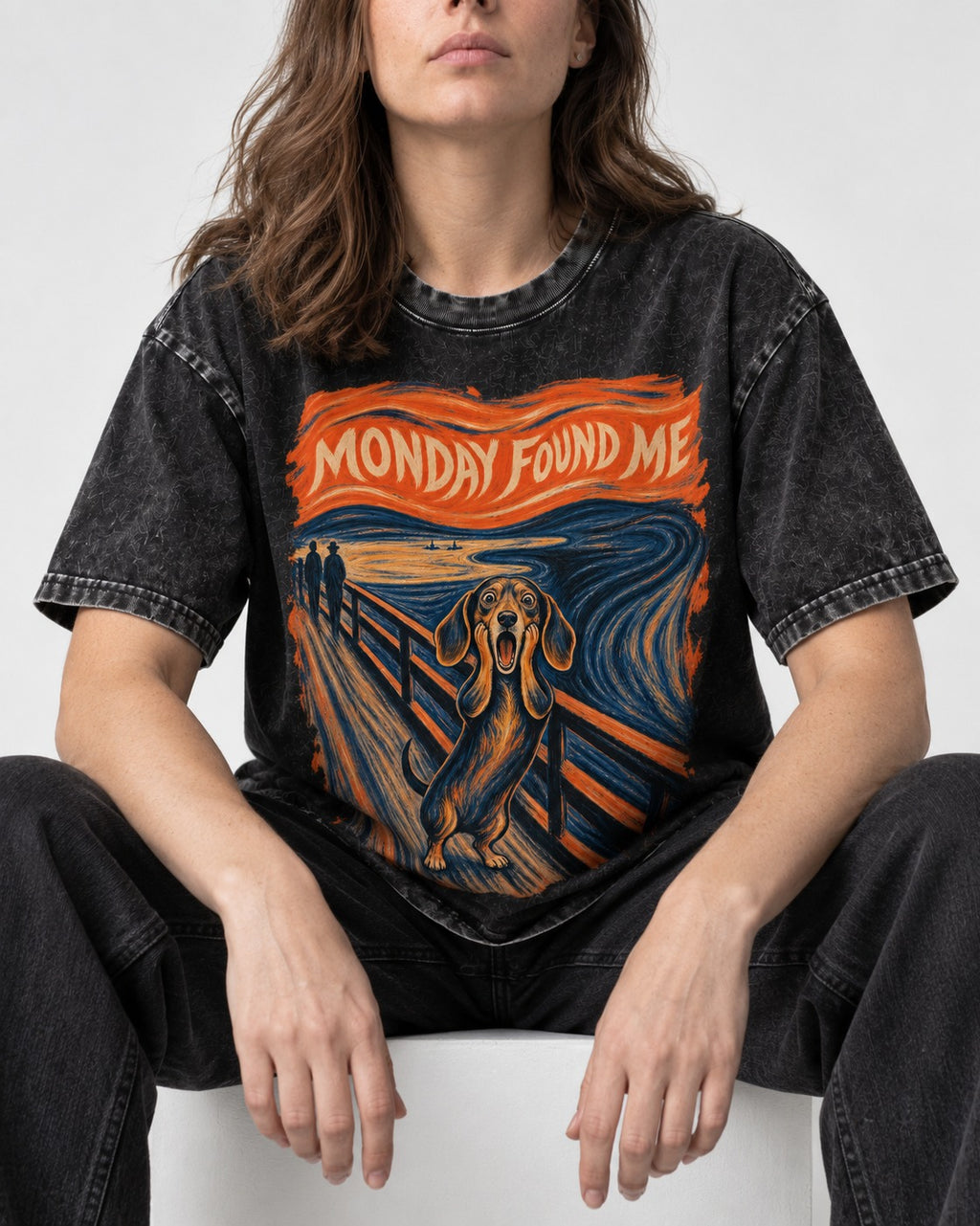 Dachshund Monday Found Me Scream Poster Washed Tee in Black, worn by a seated model
