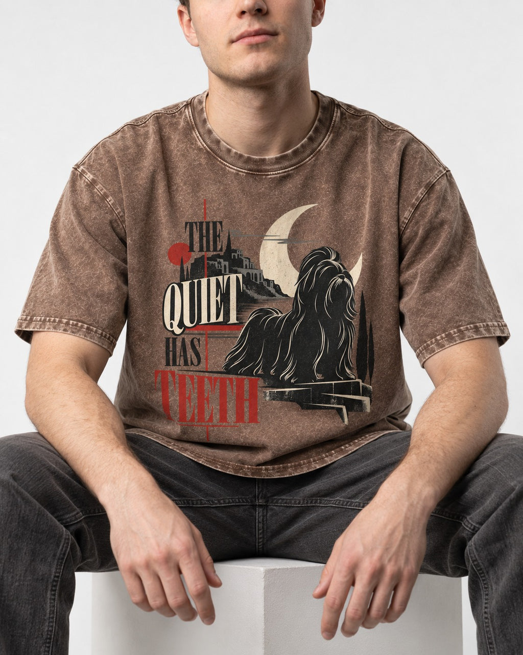 The Quiet Shih Tzu Has Teeth Washed Tee in Coffee, worn by a seated model