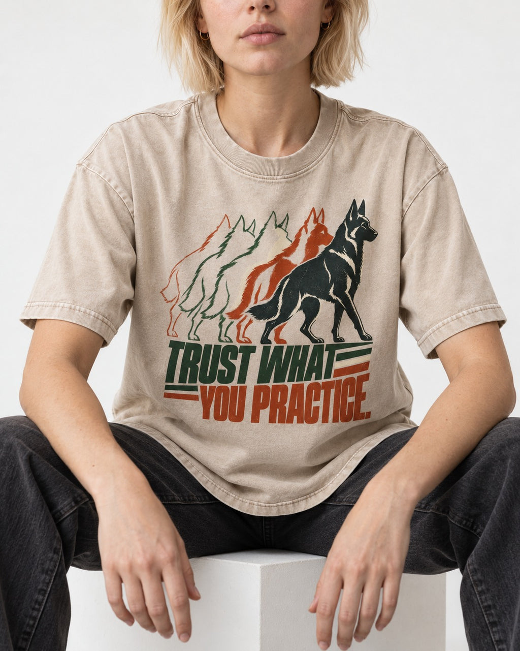 Trust What You Practice German Shepherd Dog Washed Tee in Apricot, worn by a seated model