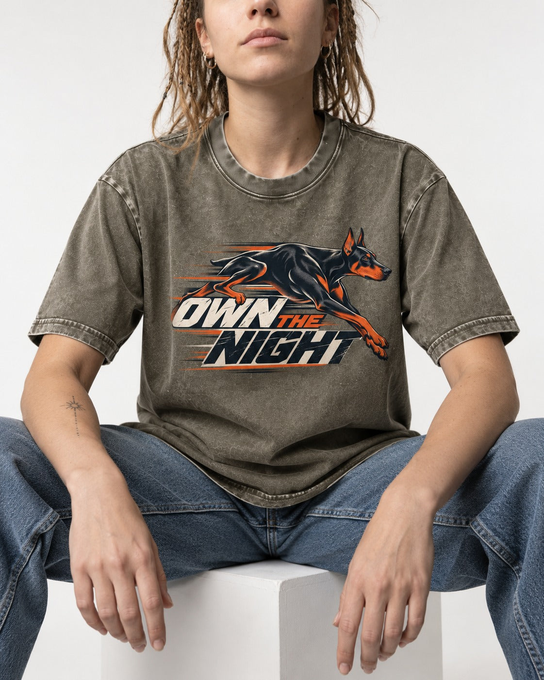 Doberman Own the Night Speed Graphic Washed Tee in Army Green, worn by a seated model