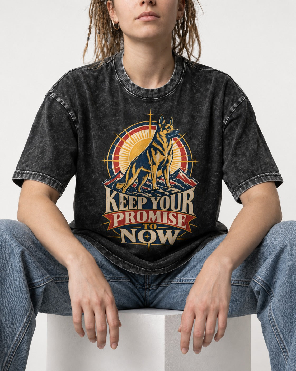 Keep Your Promise To Now Sunrise German Shepherd Dog Graphic Washed Tee in Black, worn by a seated model
