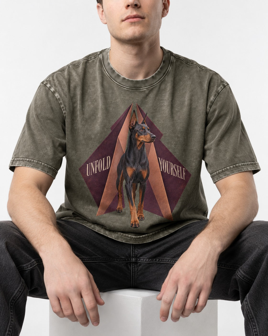 Doberman Unfold Yourself Geometric Portrait Graphic Washed Tee in Army Green, worn by a seated model