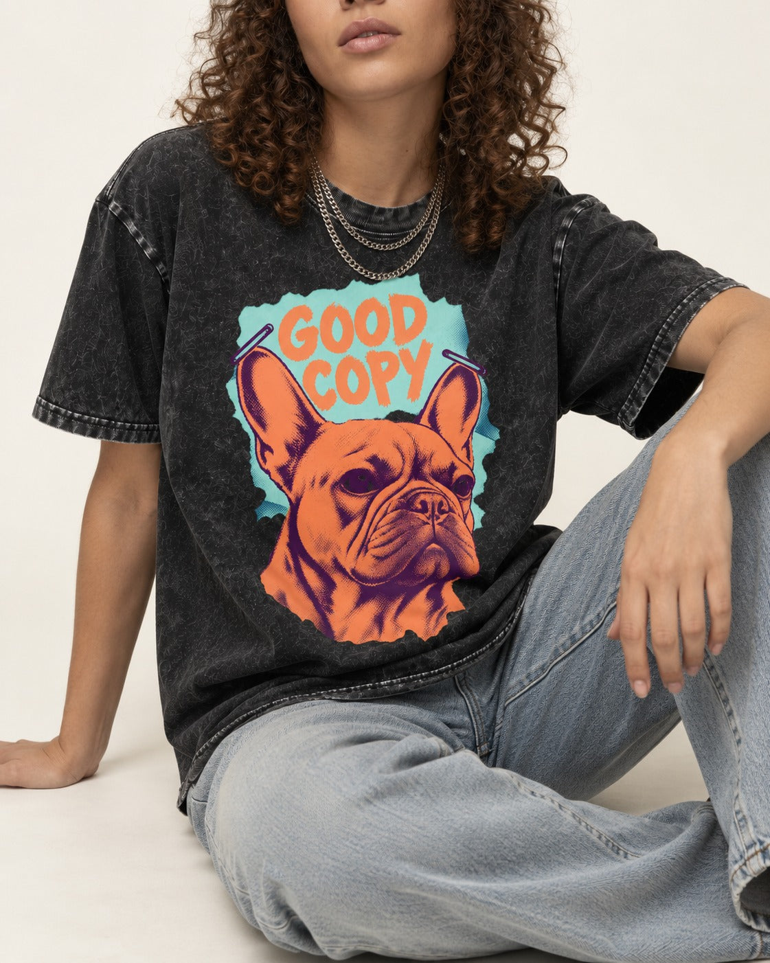 Frenchie Good Copy Stapled Zine Graphic Washed Tee in Black, worn by a seated model
