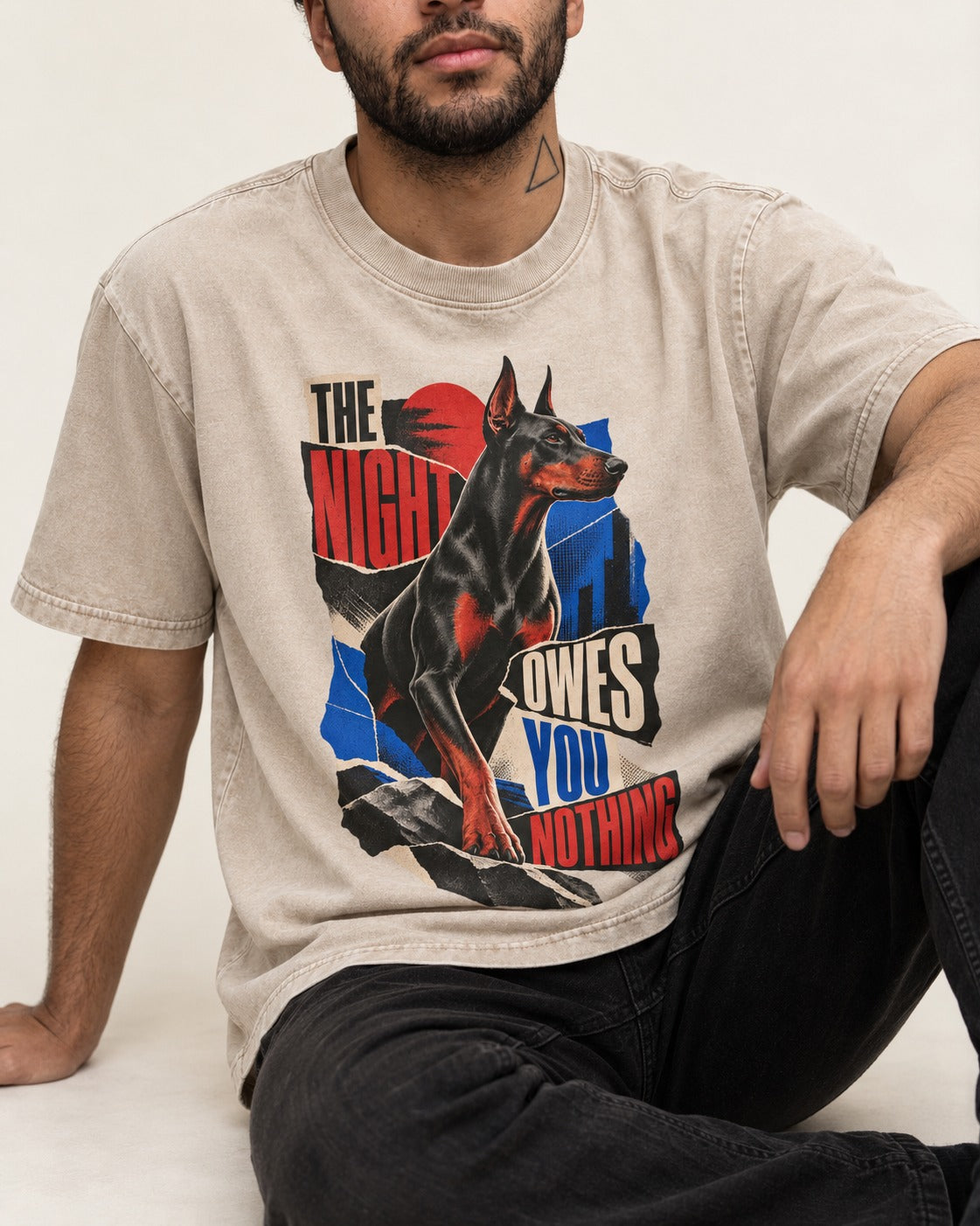 Night Owes You Nothing Doberman Washed Tee in Apricot, worn by a seated model