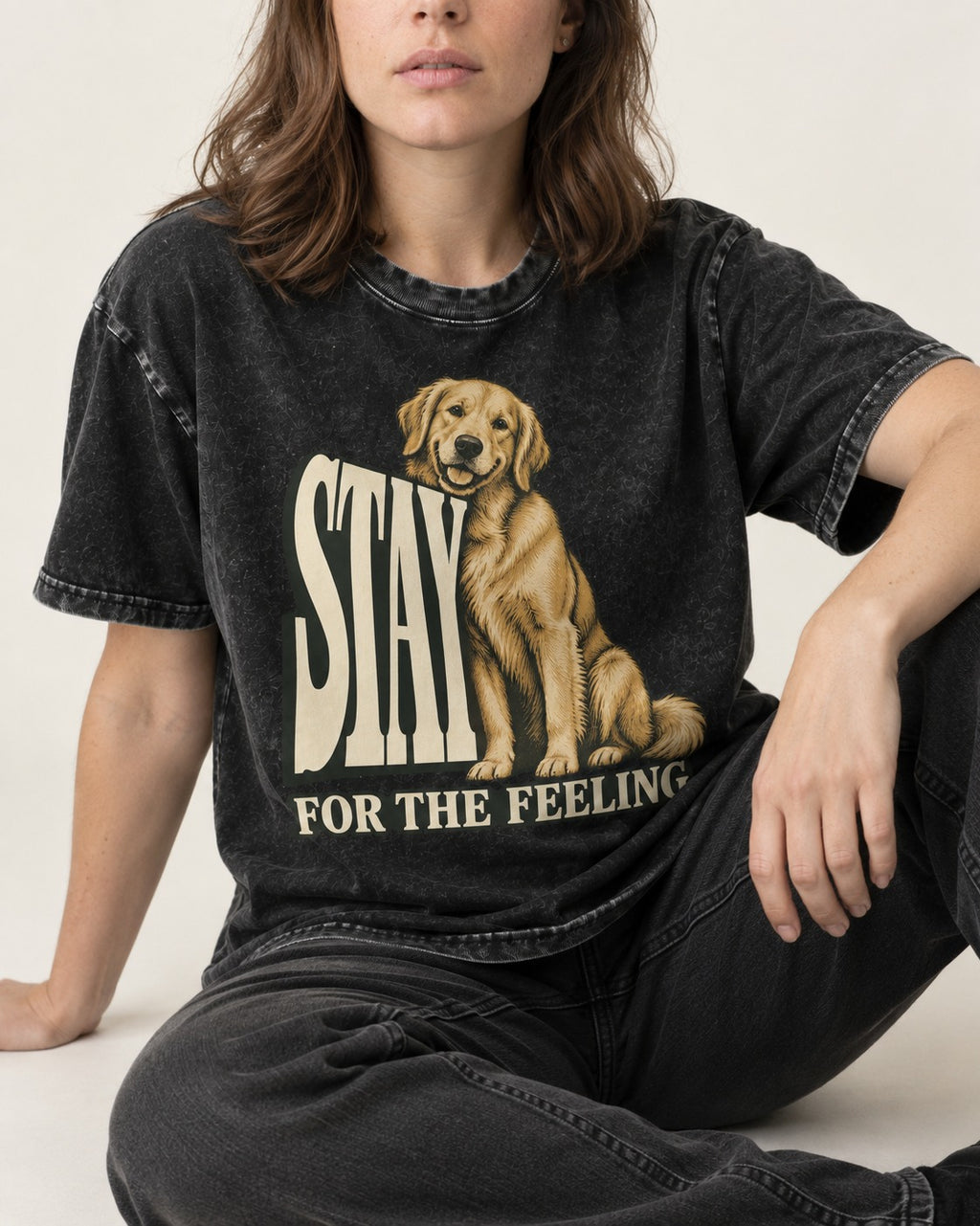 Golden Retriever Stay for the Feeling Leaning Puppy Graphic Washed Tee in Black, worn by a seated model
