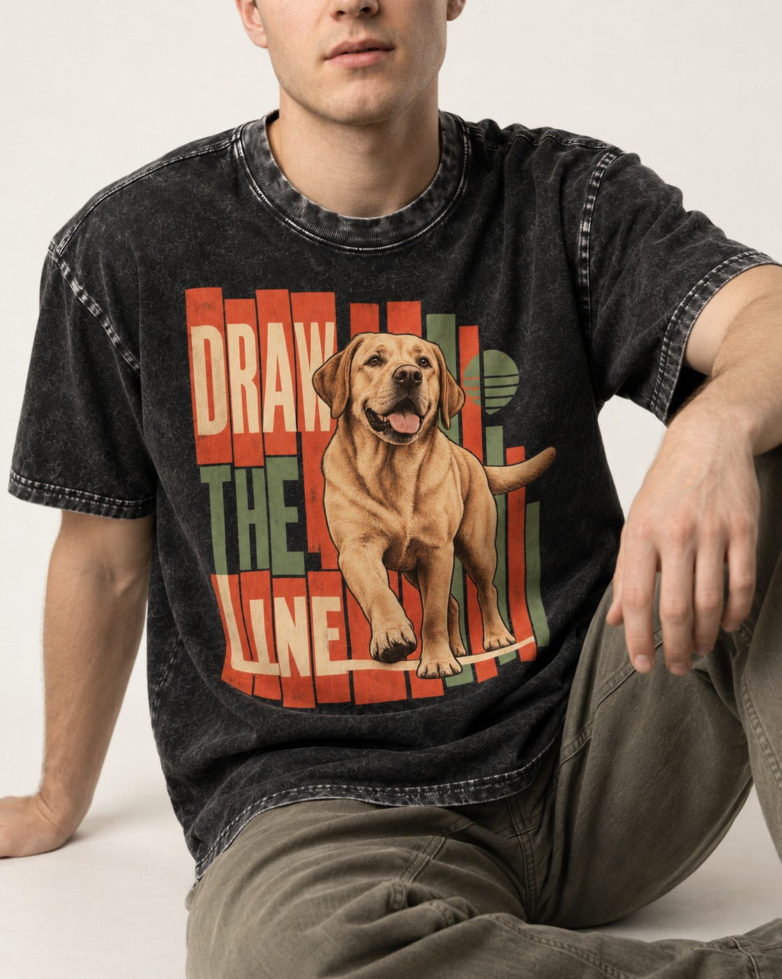 Labrador Retriever Draw the Line Stepping Graphic Washed Tee in Black, worn by a seated model