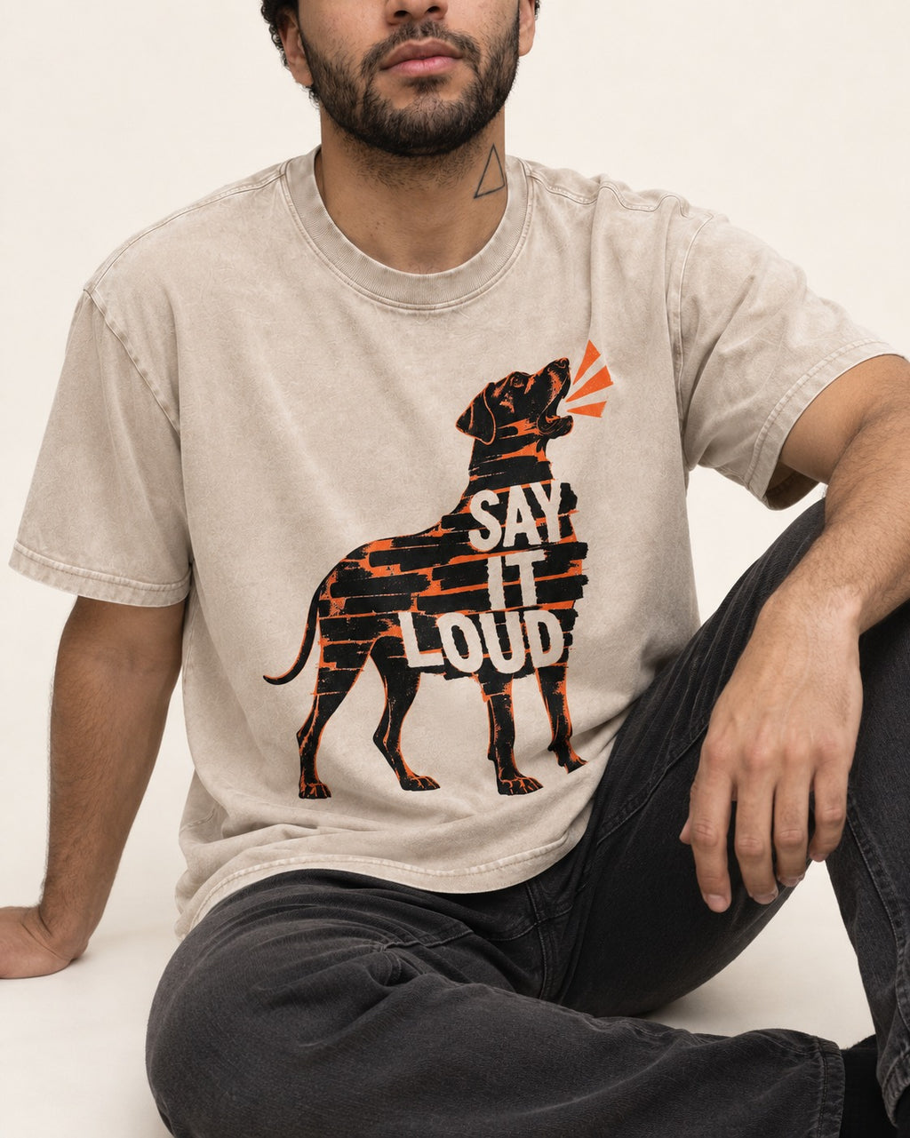 Great Dane Say It Loud Washed Tee in Apricot, worn by a seated model