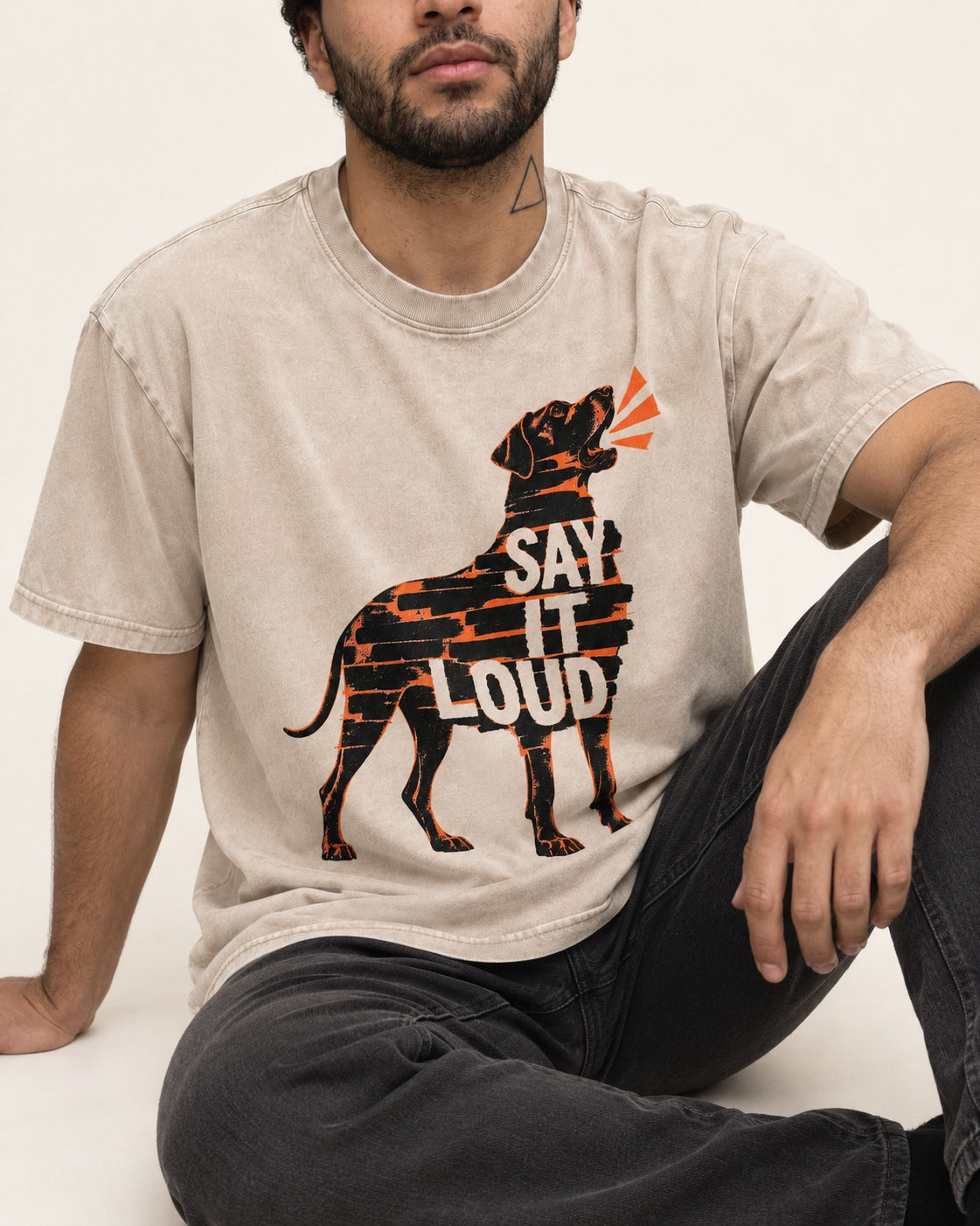 Great Dane Say It Loud Washed Tee in Apricot, worn by a seated model