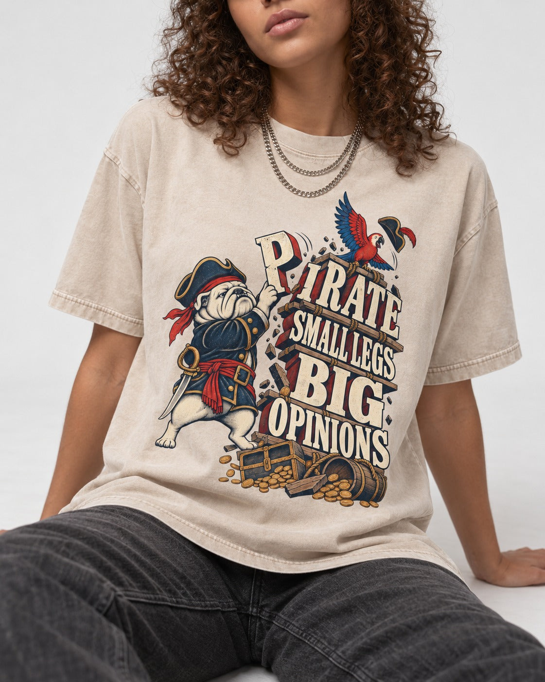 Pirate English Bulldog Big Opinions Washed Tee in Apricot, worn by a seated model