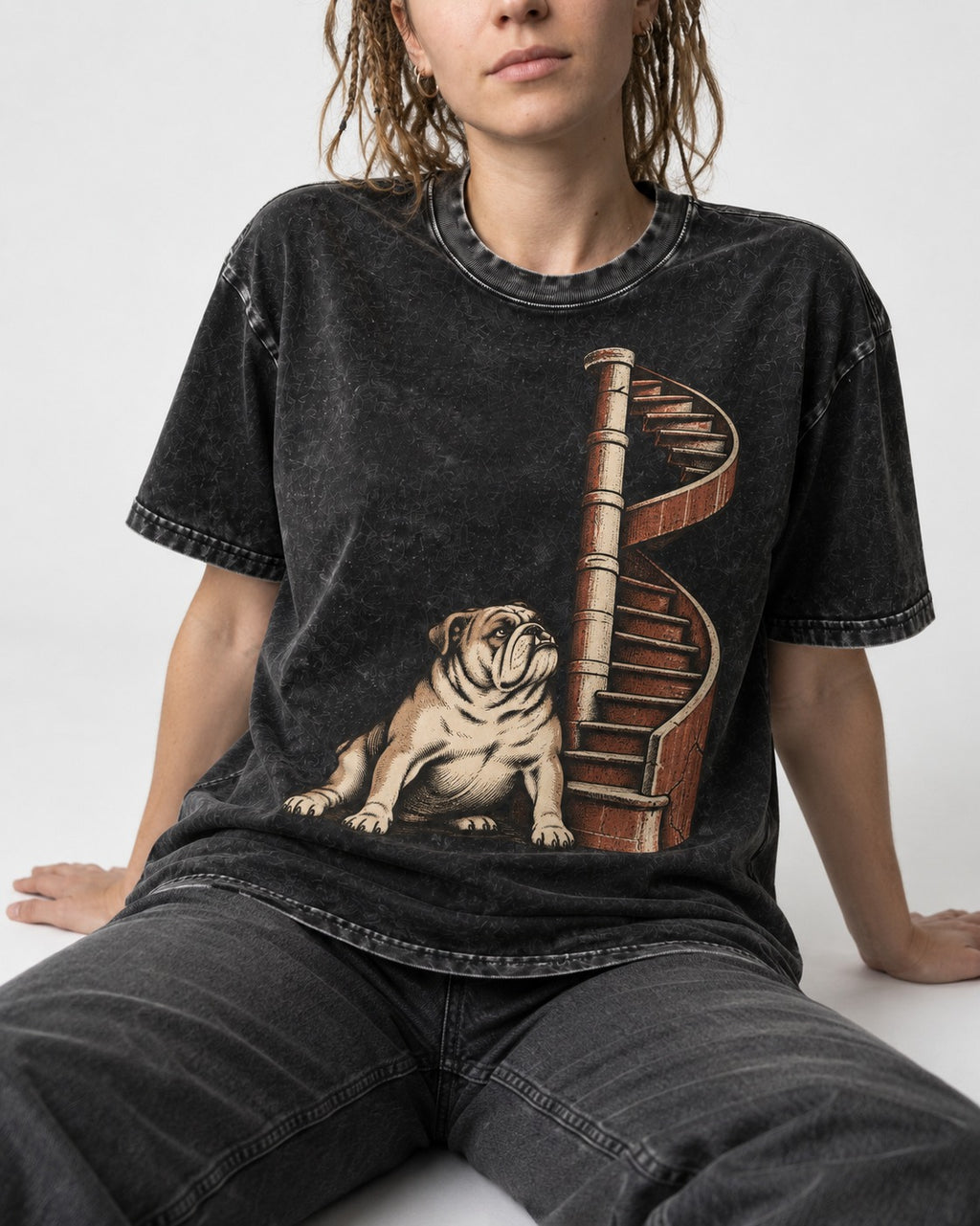 English Bulldog Spiral Staircase Graphic Washed Tee in Black, worn by a seated model