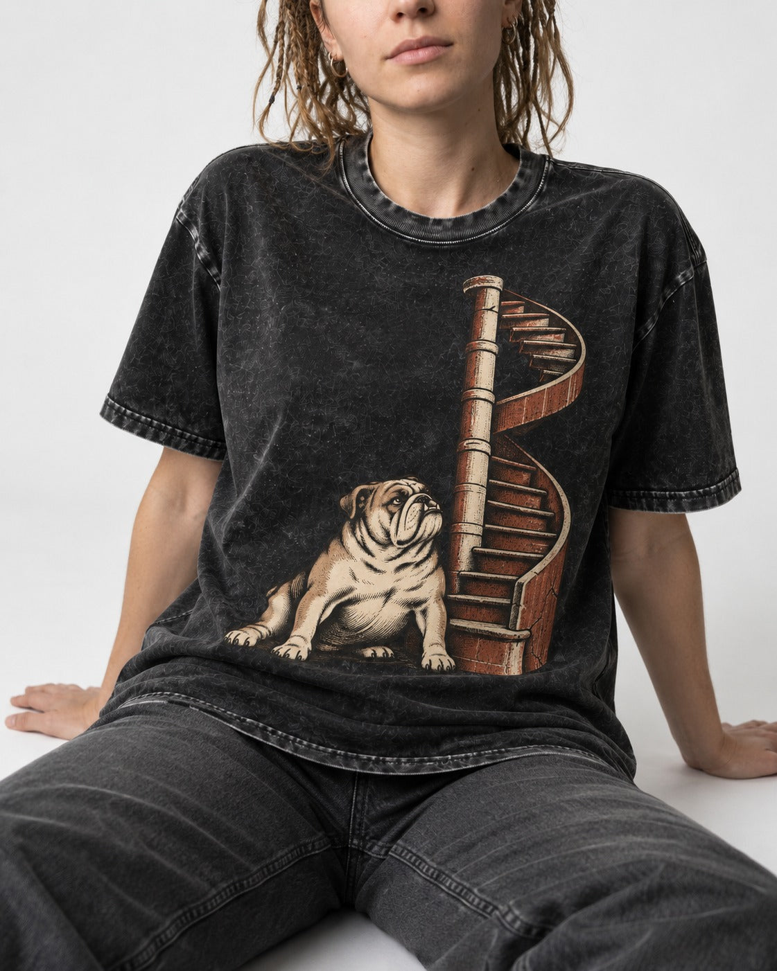 English Bulldog Spiral Staircase Graphic Washed Tee in Black, worn by a seated model